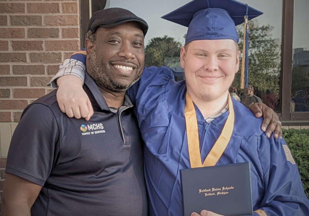 teenager graduating high school posing with a director at MCHS
