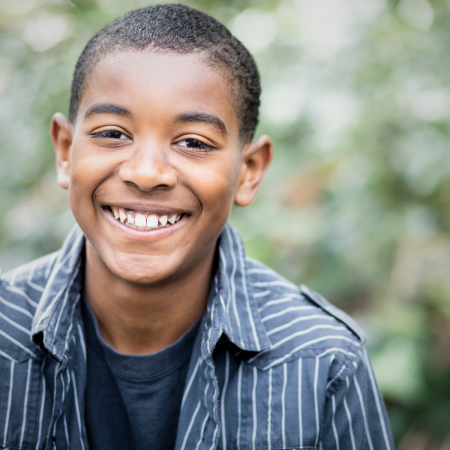 teenage boy smiling outside