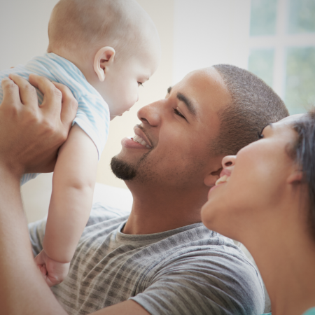 parents holding baby